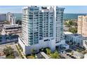 Aerial view of a modern highrise building near the water at 540 N Tamiami Trl # 702, Sarasota, FL 34236