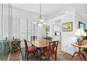 Bright dining room featuring a wood table and hardwood floors at 554 Fallbrook Dr, Venice, FL 34292