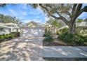 Attractive home with a large tree and paved driveway at 554 Fallbrook Dr, Venice, FL 34292