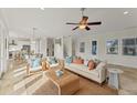 Bright living room with comfy seating, large windows, and open floor plan at 634 Key Royale Dr, Holmes Beach, FL 34217