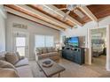 Living room with wood ceilings, comfy sofas, and large TV at 6424 Midnight Pass Rd # 12A, Sarasota, FL 34242