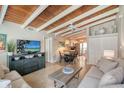 Open concept living space with wood ceilings and kitchen view at 6424 Midnight Pass Rd # 12A, Sarasota, FL 34242