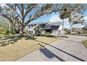 Two-story house with white exterior, dark gray accents, and a long driveway at 6706 88Th E St, Bradenton, FL 34202