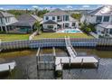 Beautiful waterfront home with a private dock, outdoor pool, and lush landscaping at 696 Regatta Way, Bradenton, FL 34208