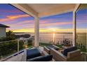 Relaxing waterfront patio boasts sunset views and comfortable seating at 696 Regatta Way, Bradenton, FL 34208