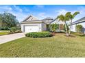 House exterior featuring a two-car garage and lush landscaping at 7521 Ridgelake Cir, Bradenton, FL 34203