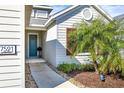 Front walkway to teal front door, nicely landscaped at 7521 Ridgelake Cir, Bradenton, FL 34203