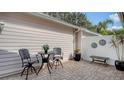 Small patio with seating area and decorative wall art at 7741 Whitebridge Gln, University Park, FL 34201