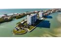 Exclusive waterfront condo complex with private beach access and lush landscaping at 9397 Midnight Pass Rd # 404, Sarasota, FL 34242