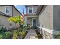 Cozy front porch area with comfortable seating and an American flag at 10109 Milky Way Cir, Sarasota, FL 34241