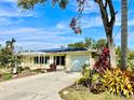 Single-story home with solar panels and a landscaped yard at 1414 6Th W St, Palmetto, FL 34221