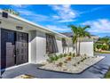 Modern dark brown double front doors and a landscaped walkway at 1608 Honey Ct, Venice, FL 34293