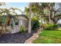 Brick house exterior with a brick walkway and tropical landscaping at 1947 W Leewynn Dr, Sarasota, FL 34240