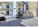 Condo building entrance with stairs and landscaping at 2723 Orchid Oaks Dr # 104, Sarasota, FL 34239