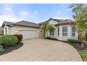 One story house with circular driveway and palm trees at 2763 Phoenix Palm Ter, North Port, FL 34288