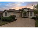 One story house with circular driveway and palm trees at 2763 Phoenix Palm Ter, North Port, FL 34288