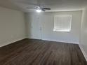 Spacious living room with dark laminate flooring and ceiling fan at 2807 W 52Nd Ter, Bradenton, FL 34207