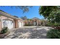 Elegant home with a three-car garage and inviting walkway at 282 Shell Midden Ct, Osprey, FL 34229