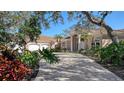 Stunning home showcasing a spacious driveway and lush landscaping at 282 Shell Midden Ct, Osprey, FL 34229