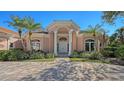 Impressive two-story home with a grand entrance and manicured landscaping at 282 Shell Midden Ct, Osprey, FL 34229