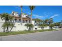 House with palm trees, white walls, and a metal roof at 345 Madison Dr, Sarasota, FL 34236