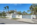 Two-story house with light blue gates and artistic wall decor at 345 Madison Dr, Sarasota, FL 34236