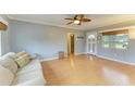 Light and airy living room with light hardwood floors and ceiling fan at 3601 Yardley N Ave, St Petersburg, FL 33713