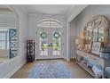 Bright and airy entryway with double doors and a stylish console table at 366 S Creek Ct, Osprey, FL 34229