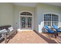 Inviting front porch with double doors, a bench, and comfortable seating at 366 S Creek Ct, Osprey, FL 34229