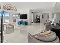 Open concept living area with water views, stylish furnishings, and high ceilings at 400 Golden Gate Pt # 11, Sarasota, FL 34236