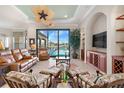 Spacious living room with water views, leather furniture, and built-ins at 4110 Commodore Blvd, Cortez, FL 34215