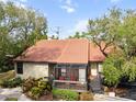 Aerial view showcasing a charming villa with a terracotta roof and lush landscaping at 4351 Trails Dr # 4-2, Sarasota, FL 34232