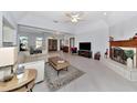 Spacious living room featuring a fireplace and light-colored flooring at 4679 Country Manor Dr, Sarasota, FL 34233