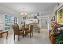 Charming dining area with a glass table and four chairs, near the kitchen at 4705 Sand Trap Street E Cir # 106, Bradenton, FL 34203