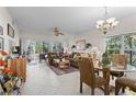 Bright and airy living room with tile flooring and access to a screened patio at 4705 Sand Trap Street E Cir # 106, Bradenton, FL 34203