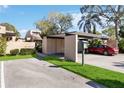 Carport with a red car parked and green space at 5269 Myrtle Wood Rd # 35, Sarasota, FL 34235