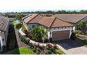 Single-story house with a tile roof and a landscaped yard at 5337 Popoli Way, Sarasota, FL 34238