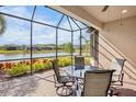 Screened patio overlooking a lake, with seating for four at 5337 Popoli Way, Sarasota, FL 34238