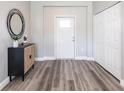 Bright entryway with gray vinyl flooring and closet at 5534 Fairlane Dr, North Port, FL 34288