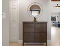 Entryway with a dark brown shoe cabinet and a circular mirror at 5640 Westwind Ln, Sarasota, FL 34231