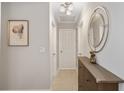 Bright hallway with light walls and a dark brown cabinet at 5640 Westwind Ln, Sarasota, FL 34231