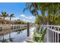 Relaxing waterfront dock with green chairs overlooking a peaceful canal at 579 Fore Dr, Bradenton, FL 34208