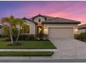 One-story home with tile roof, two-car garage, and manicured lawn at 6534 Clairborne Ln, Lakewood Ranch, FL 34211