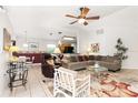 Bright living room with a sectional sofa and a view into the kitchen at 6950 42Nd E Ct, Sarasota, FL 34243