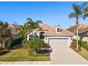 Single-Gathering home with tile roof, landscaping, and two-car garage at 7121 Orchid Island Pl, Bradenton, FL 34202