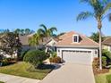 Single-Gathering home with tile roof, landscaping, and two-car garage at 7121 Orchid Island Pl, Bradenton, FL 34202