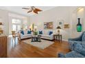 Bright living room with hardwood floors, comfortable seating, and large windows at 7121 Orchid Island Pl, Bradenton, FL 34202