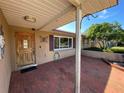 Brick porch with wooden door and window, inviting entryway at 7307 9Th Nw Ave, Bradenton, FL 34209