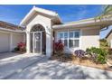 Front entry with decorative iron door and well-maintained landscaping at 8240 Parkside Dr, Englewood, FL 34224