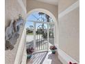 Bright and airy front entry with tiled floor and arched doorway at 8240 Parkside Dr, Englewood, FL 34224